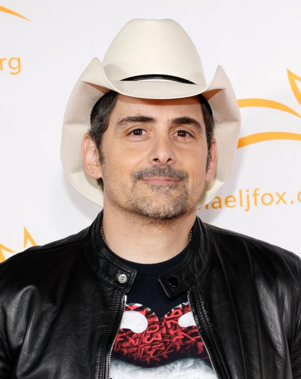 Brad Paisley attends the Michael J. Fox Foundation - A Country Thing: Happened On The Way To Cure Parkinson's. He's wearing a black jacket over a Rolling Stones t-shirt and his cowboy hat.