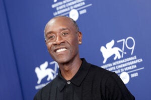 Don Cheadle attends the photocall for "White Noise" at the 79th Venice International Film Festival smiling wearing a black button up shirt.