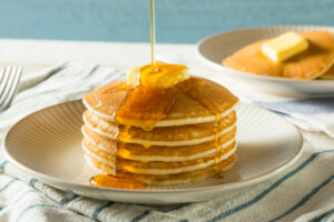 Food-themed accommodations - Sweet Homemade Stack of Pancakes with Butter and Syrup for Breakfast