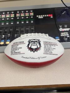 2022 UGA collectible football in front of a radio station operating board