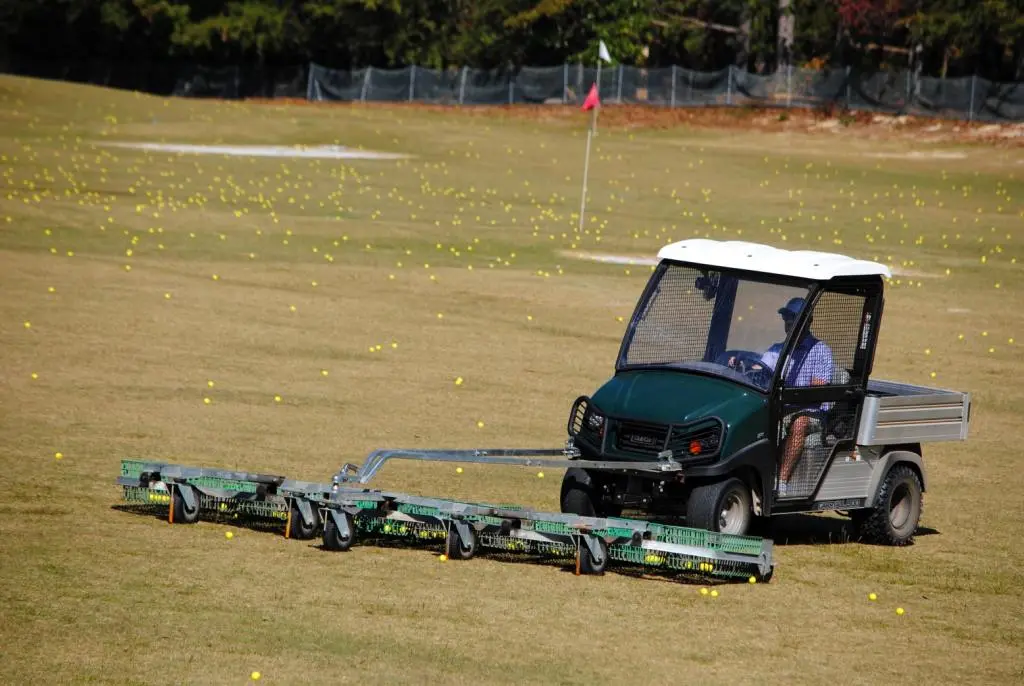 Bryan 'Dub' Axelson takes some time away from the broadcast booth to clean up some of the thousands of balls hit onto the range each day at Wedges & Woods.